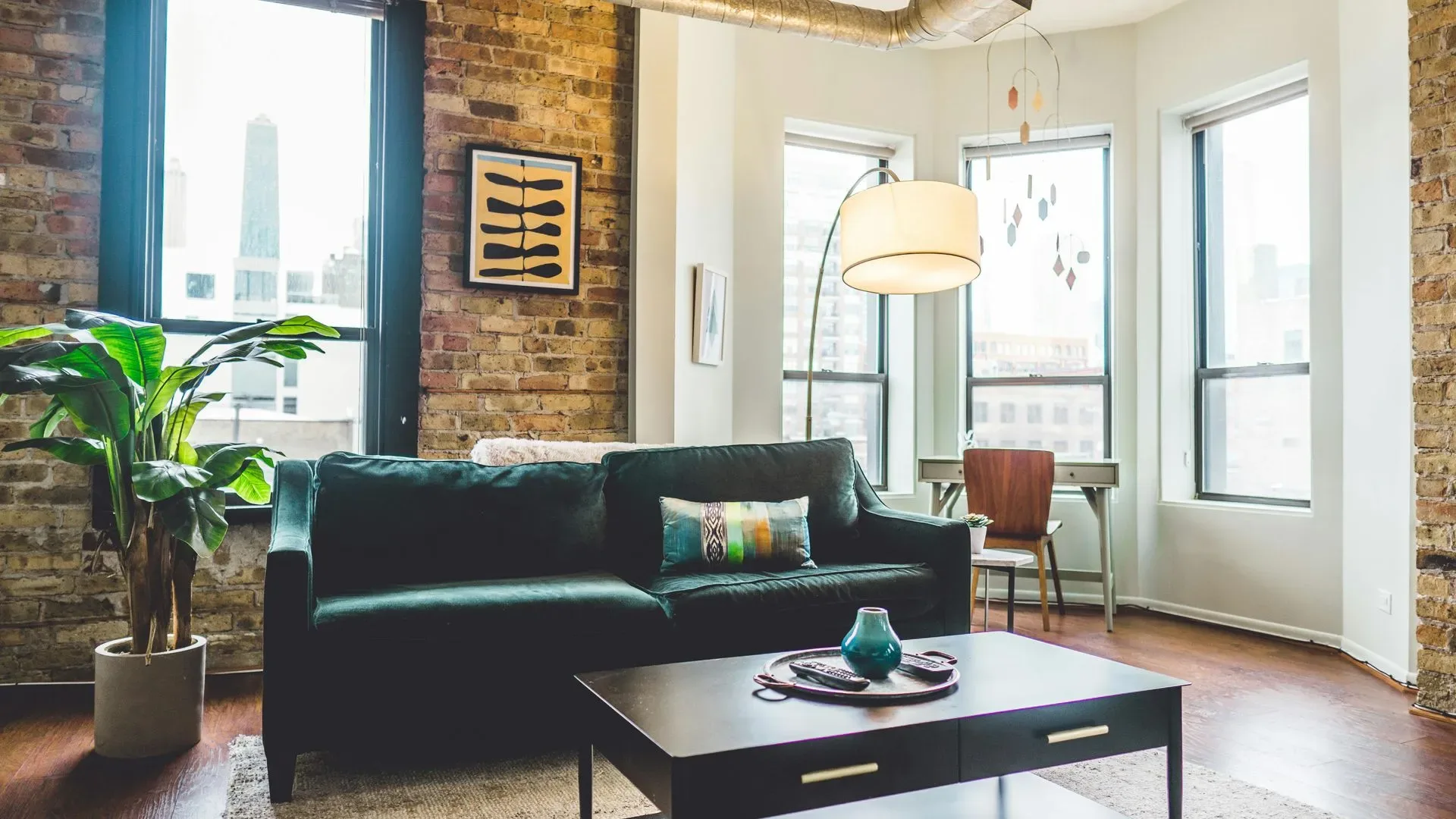 Remodeled living room with exposed brick and large windows