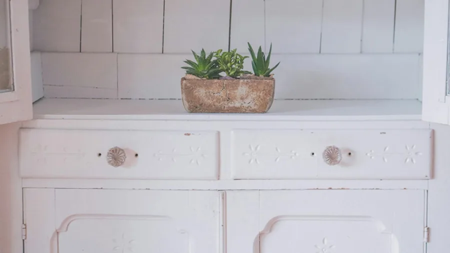 Custom cabinetry with a painted finish and open display shelf